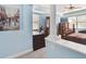 Comfortable main bedroom featuring a sitting area, large windows, and elegant furnishings at 19432 Whispering Brook Dr, Tampa, FL 33647