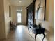 Welcoming hallway with tiled floors, decorative barn door and attractive front door, enhancing the home's appeal at 2206 Landside Dr, Valrico, FL 33594