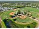 Aerial view of baseball fields and ponds in a community surrounded by lush greenery at 22647 Eagles Watch Dr, Land O Lakes, FL 34639