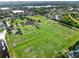 Aerial view of soccer and baseball fields within a lush green community with ponds at 22647 Eagles Watch Dr, Land O Lakes, FL 34639