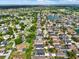 Community aerial view showcases a beautiful neighborhood with mature trees and a pond at 22647 Eagles Watch Dr, Land O Lakes, FL 34639