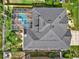 An aerial view shows the roof, solar panels, screened-in pool and manicured backyard of the home at 22647 Eagles Watch Dr, Land O Lakes, FL 34639