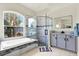 Bright bathroom featuring a soaking tub and standing shower at 22647 Eagles Watch Dr, Land O Lakes, FL 34639