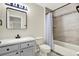 Bathroom featuring a vanity with sink, toilet, and shower/tub combo with stylish tile at 22647 Eagles Watch Dr, Land O Lakes, FL 34639