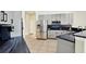 Kitchen with gray cabinets, black countertops, stainless steel appliances and tile flooring at 22647 Eagles Watch Dr, Land O Lakes, FL 34639