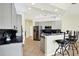 A spacious kitchen with gray cabinets, black countertops, stainless steel appliances, and bar stool seating at 22647 Eagles Watch Dr, Land O Lakes, FL 34639