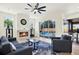 Bright living room with fireplace, plush seating, and access to outdoor pool at 22647 Eagles Watch Dr, Land O Lakes, FL 34639