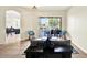 Bright and airy living room with a sliding glass door leading to an outside pool and patio at 22647 Eagles Watch Dr, Land O Lakes, FL 34639