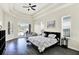 Bright main bedroom featuring tray ceilings, hardwood floors, and pool access at 22647 Eagles Watch Dr, Land O Lakes, FL 34639