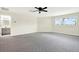 Main bedroom with attached bathroom, large windows, and modern ceiling fan with lights at 22647 Eagles Watch Dr, Land O Lakes, FL 34639