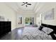 Bright main bedroom featuring tray ceilings, hardwood floors, and seating at 22647 Eagles Watch Dr, Land O Lakes, FL 34639