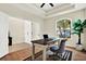 Bright home office featuring natural wood flooring, a ceiling fan, and a bright window at 22647 Eagles Watch Dr, Land O Lakes, FL 34639