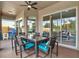 Covered patio with dining area features a fan, lighting, and sliding glass doors at 22647 Eagles Watch Dr, Land O Lakes, FL 34639