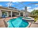 Screened-in pool and spa, with an outdoor dining area, offer a resort-style backyard experience at 22647 Eagles Watch Dr, Land O Lakes, FL 34639