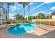 Relax in this beautiful screened-in pool and spa with lush landscaping in the backyard at 22647 Eagles Watch Dr, Land O Lakes, FL 34639