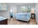 Cozy bedroom with a comfortable bed, wood-look flooring, and natural light at 2348 Shelley St # 8, Clearwater, FL 33765
