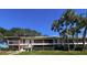 Two-story apartment building with mature palm trees and brick facade accents at 2348 Shelley St # 8, Clearwater, FL 33765