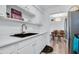 Clean kitchen showcases white cabinets, stainless steel sink, and tile backsplash at 2348 Shelley St # 8, Clearwater, FL 33765