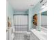 Bright bathroom offers white cabinetry, tile floors, and a shower/tub combo at 2400 Feather Sound Dr # 1118, Clearwater, FL 33762