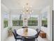 Bright dining area features large windows and a modern sputnik chandelier at 2400 Feather Sound Dr # 1118, Clearwater, FL 33762