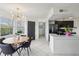 Bright dining area features a modern chandelier and kitchen view with stainless steel appliances at 2400 Feather Sound Dr # 1118, Clearwater, FL 33762