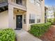 Condo's front door features a black door, house number and a concrete walkway at 2400 Feather Sound Dr # 1118, Clearwater, FL 33762