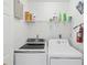 Laundry room features modern washing machine and dryer at 2400 Feather Sound Dr # 1118, Clearwater, FL 33762