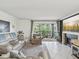 Bright living room with a fireplace, a screened-in patio and stylish furnishings at 2400 Feather Sound Dr # 1118, Clearwater, FL 33762