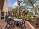 Charming outdoor patio area with tables, chairs, umbrellas, and lush landscaping, perfect for relaxation at 2400 Feather Sound Dr # 1118, Clearwater, FL 33762