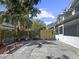Backyard featuring a paved patio, lush trees, privacy fence, and a charming bench at 2523 Northfield Ln, Clearwater, FL 33761