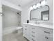 Modern bathroom featuring a spacious vanity, ample lighting and a shower/tub combo at 2523 Northfield Ln, Clearwater, FL 33761