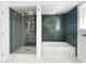 Modern bathroom featuring separate tub and shower with beautiful blue tile accents and ample space at 2523 Northfield Ln, Clearwater, FL 33761