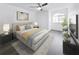 Bedroom featuring stylish decor, wood flooring, a large window, and bright lighting at 2523 Northfield Ln, Clearwater, FL 33761