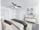Bedroom showcasing hardwood floors, ceiling fan, shelves, and stylish furnishings at 2523 Northfield Ln, Clearwater, FL 33761