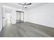 Spacious bedroom featuring wood floors, a ceiling fan, and a closet at 2523 Northfield Ln, Clearwater, FL 33761