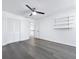 Bedroom with hardwood floors, a ceiling fan, closet and built-in shelves at 2523 Northfield Ln, Clearwater, FL 33761