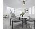 Dining room showcases updated flooring, sleek decor, and a modern dining set at 2523 Northfield Ln, Clearwater, FL 33761