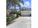 Charming exterior elevation of home featuring a two-car garage and well-maintained landscaping at 2523 Northfield Ln, Clearwater, FL 33761