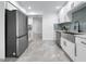 Bright kitchen showcasing stainless steel appliances, white cabinetry, and stylish countertops at 2523 Northfield Ln, Clearwater, FL 33761