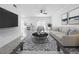 Beautifully staged living room with sleek furnishings, stylish rug, and flat screen television at 2523 Northfield Ln, Clearwater, FL 33761
