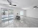 Open living area features new tile floors, a ceiling fan, and sliding glass doors to the exterior at 2523 Northfield Ln, Clearwater, FL 33761