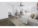 Staged main bedroom with ceiling fan, wood floors, vanity area, and a large window at 2523 Northfield Ln, Clearwater, FL 33761