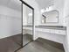 Walk-in closet featuring a built-in vanity, mirror, and sliding doors for convenient access at 2523 Northfield Ln, Clearwater, FL 33761