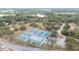 A scenic aerial view showcases a community park with tennis courts, an ice rink, and a picturesque lake in the background at 2610 E Yukon St, Tampa, FL 33604