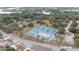 Overhead shot of tennis and pickleball courts with an ice rink in the park, framed by mature trees and surrounding roadways at 2610 E Yukon St, Tampa, FL 33604
