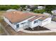 Aerial view of charming home featuring a new roof, manicured landscaping, and an attached garage at 2610 E Yukon St, Tampa, FL 33604
