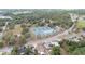 An aerial view of a community park featuring tennis courts and an ice rink surrounded by lush greenery at 2610 E Yukon St, Tampa, FL 33604