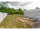 Spacious backyard area with partial metal shed and white vinyl fence at 2610 E Yukon St, Tampa, FL 33604