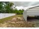 Backyard featuring metal shed and white vinyl fence on a spacious property at 2610 E Yukon St, Tampa, FL 33604