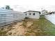 View of the spacious backyard with metal storage and white fenced perimeter at 2610 E Yukon St, Tampa, FL 33604